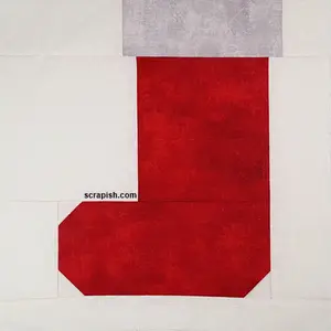 Pair this Christmas stocking quilt block pattern with other 12 inch Christmas blocks to make a table runner. Easy quilting for beginners!