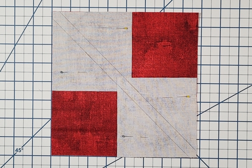 Step 3 - 4 Flying Geese At Once: Place small squares right sides down on large square. Align lines and overlap small squares at center of large square. Step 3 - 4 Flying Geese At Once: Place small squares right sides down on large square. Align lines and overlap small squares at center of large square.