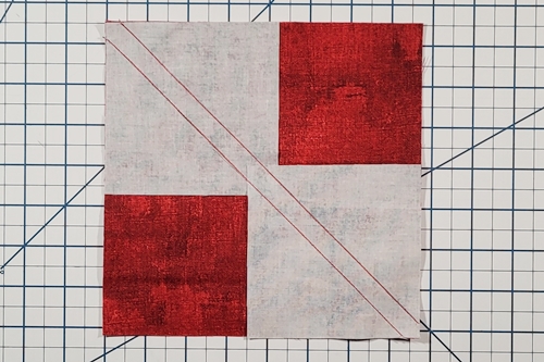 Step 4: 4 Flying Geese At Once - Stitch along each line, making 1/4 inch seams from the center diagonal of the squares. Step 4: 4 Flying Geese At Once - Stitch along each line, making 1/4 inch seams from the center diagonal of the squares.