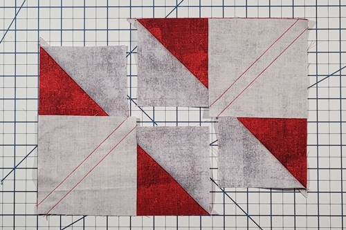 Step 7 4 Flying Geese At Once: Place large triangle/small triangles units right side up. Right side down, place small squares in 'unused' corner large triangles. Stitch each drawn line. Step 7 4 Flying Geese At Once: Place large triangle/small triangles units right side up. Right side down, place small squares in 'unused' corner large triangles. Stitch each drawn line.