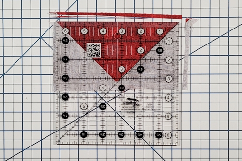 Step 11 4 Flying Geese At Once: Use a rotary cutter to make cuts along the right and top sides of the flying geese unit. Step 11 4 Flying Geese At Once: Use a rotary cutter to make cuts along the right and top sides of the flying geese unit.