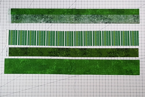 Step 1b Christmas Ornament Quilt Block Pattern: stitch a 5-strip strip set. Stitch Fabric Strip 4 to 3.