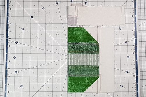 Step 7 Christmas Ornament Quilt Block Pattern: finger press a crease in the center of main square and cap sections.