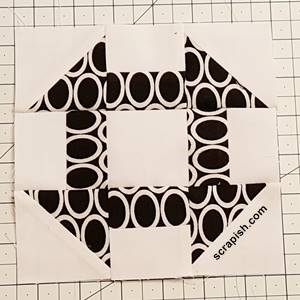 Step 8c churn dash quilt block pattern:  Stitch Row 3 to Row 2 in the same manner. Press the seam downward, toward row 3.