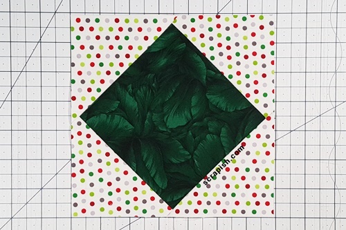 Picture of a square in a square, or diamond in a square, block after adding the corner triangles for setting blocks on point. After adding the corner triangles for setting blocks on point the square in a square, or diamond in a square, unit is complete!