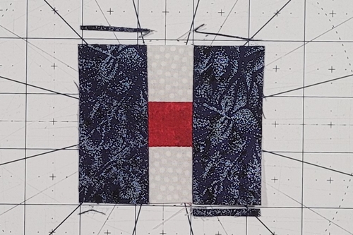 Courthouse Steps Quilt Block Pattern Step 7: Stitch a strip ('log') to the left side and then the right side of the previous unit. Trim side 'logs' even with the top and bottom of the previous unit. Courthouse Steps Quilt Block Pattern Step 7: Stitch a strip ('log') to the left side and then the right side of the previous unit. Trim side 'logs' even with the top and bottom of the previous unit.