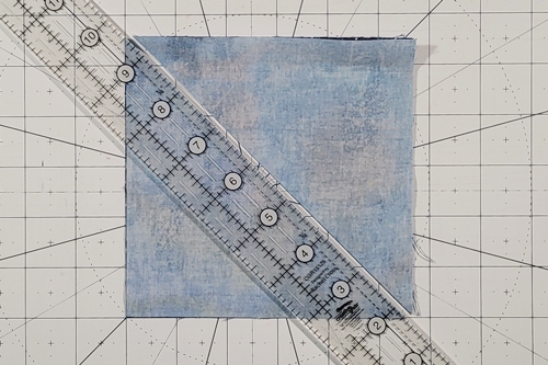 Double Friendship Star Quilt Block Tutorial Step 2: place a quilting ruler on the left leaning (\) diagonal axis and use a rotary cutter to make a cut along it. Double Friendship Star Quilt Block Tutorial Step 2: place a quilting ruler on the left leaning (\) diagonal axis and use a rotary cutter to make a cut along it.