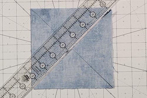Double Friendship Star Quilt Block Tutorial Step 3: place a quilting ruler on the right leaning (/) diagonal axis and use a rotary cutter to make a cut along it. Double Friendship Star Quilt Block Tutorial Step 3: place a quilting ruler on the right leaning (/) diagonal axis and use a rotary cutter to make a cut along it.