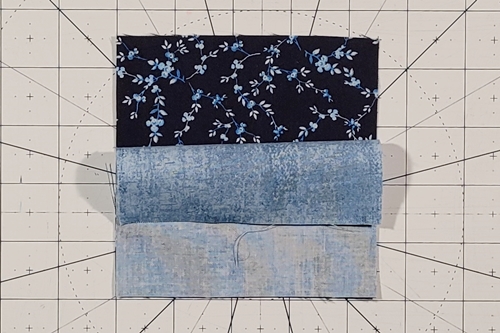 Duck Tracks Quilt Block Tutorial Step 1: Place QST squares right sides together, background square on top.