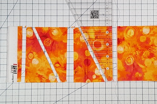 Step 1a Eight Pointed Star Quilt Block Pattern: From Fabric A strip cut 8 side triangles using the Recs Triangle Ruler.