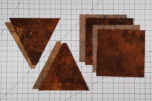 Pieces cut from the same fabric strip to make up the background of the eight pointed star quilt block: 4 center triangles and 4 squares.