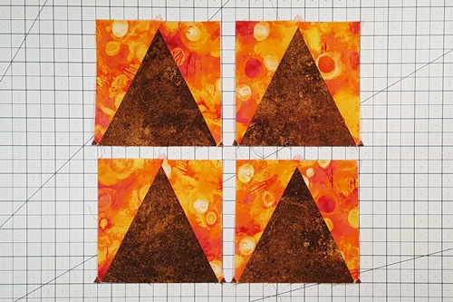 Step 5a Eight Pointed Star Quilt Block Pattern: After step 4 your triangle in a square units will look similar to these  - 
side triangles pointed down, center triangle pointed up.