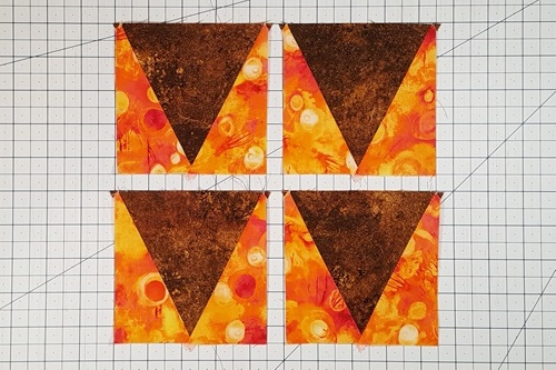 Step 5b Eight Pointed Star Quilt Block Pattern: However, to make the eight pointed star quilt block we will turn them
so that the side triangles point up in the center triangles point down.