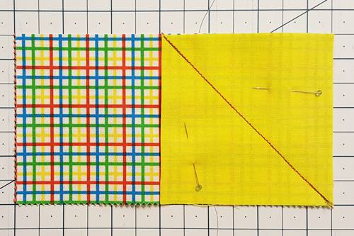 Step 3 Stitch on the drawn line from the center of the rectangle to the bottom right corner to start making a flying geese unit.