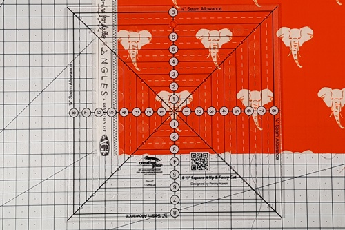 Step 4a Square in a Square: Stitch on the drawn line on the small squares. Step 1 Fussy Cut: Center the middle of the ruler over motif to be cut out.