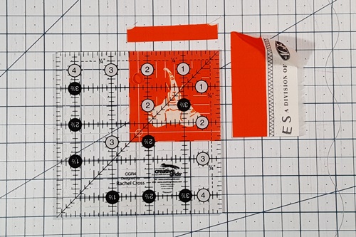 Step 5 Fussy Cut: Rotate the fabric 180 degrees. Align the ruler with the markings and cut. Step 5 Fussy Cut: Rotate the fabric 180 degrees. Align the ruler with the markings and cut.