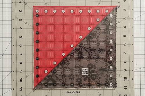 Half square triangle quilt pattern: Cutting half square triangles made from a 10 inch square layer cake. Half square triangle quilt pattern: Cutting half square triangles made from a 10 inch square layer cake.