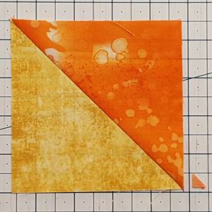 Step 7 Half square triangle ruler: Open the half square triangles with the right side of the fabric up. Press the seams as directed or towards the darker fabric. Clip the one dog ear off the HST. Step 7 Half square triangle ruler: Open the half square triangles with the right side of the fabric up. Press the seams as directed or towards the darker fabric. Clip the one dog ear off the HST.