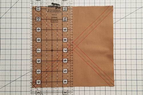 Step 3 Place a quilting ruler through the vertical center of the squares and make a cut through the center of the squares. Step 3 Place a quilting ruler through the vertical center of the squares and make a cut through the center of the squares.