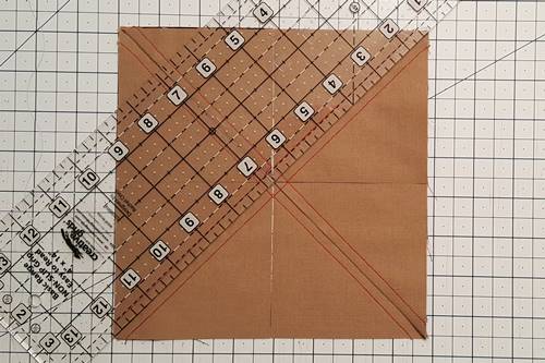 Step 6 Place the ruler diagonally from the other corners on the drawn line. Make a cut with the rotary cutter. Step 6 Place the ruler diagonally from the other corners on the drawn line. Make a cut with the rotary cutter.