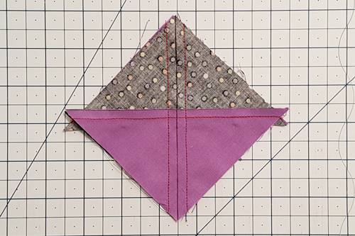 Step 3 Hourglass Quilt Block: Stitch a 1/4 inch seam away from both sides of the marked line. Step 3 Hourglass Quilt Block: Stitch a 1/4 inch seam away from both sides of the marked line.