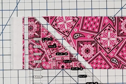 How to Make Flying Geese Step 3: make a cut along both edges of the ruler.