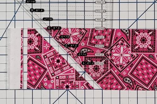 How to Make Flying Geese Step 4: rotate the ruler 180 degrees and align the angled side with the angled side of the fabric strip.