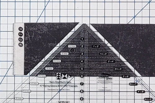How to Make Flying Geese Step 9: make a cut along both sides of the ruler.