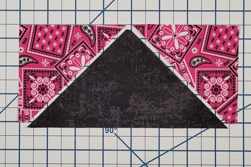 How to Make Flying Geese Step 11: Layout your pieces right side up with the QST in the middle and one HST on either side of it as shown in the photo below.