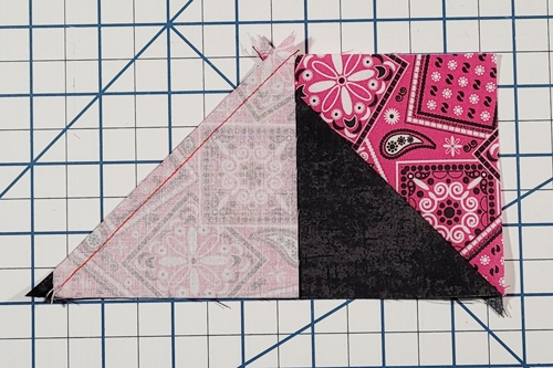 How to Make Flying Geese Step 14: Place left HST, right side down, on top of QST. Align bottom and angled edges of both. Blunt tip of HST aligns as before. Top edge of HST overlaps first HST. Stitch.