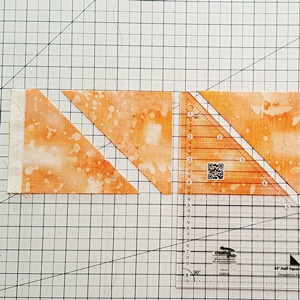 Step 1a Maple Leaf Quilt Pattern: Cut Half Square Triangles with half square triangle ruler.