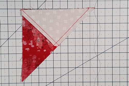 Step 3b Ohio Star Quilt Block Pattern: With right sides together, place the bottom set of triangles over the top set and stitch a 1/4 inch seam along diagonal edge. Step 3b Ohio Star Quilt Block Pattern: With right sides together, place the bottom set of triangles over the top set and stitch a 1/4 inch seam along diagonal edge.