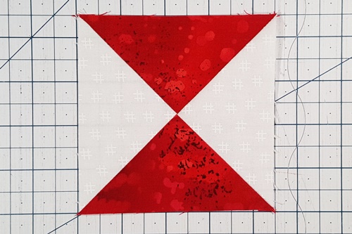 Step 3c Ohio Star Quilt Block Pattern: Press the seam in either direction and flip the bottom set of triangles right side up. Step 3c Ohio Star Quilt Block Pattern: Press the seam in either direction and flip the bottom set of triangles right side up.