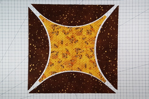 Step 11 Orange Peel Quilt Block: Place the background piece from one square and the half melons from the second square onto your cutting mat. Step 11 Orange Peel Quilt Block: Place the background piece from one square and the half melons from the second square onto your cutting mat.