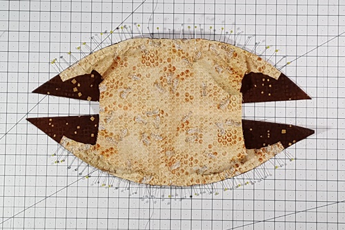 Step 13 Orange Peel Quilt Block: Here's how the pinning looks from the background side. You can see that the background has been stretched to match the curve of the half melons. Step 13 Orange Peel Quilt Block: Here's how the pinning looks from the background side. You can see that the background has been stretched to match the curve of the half melons.