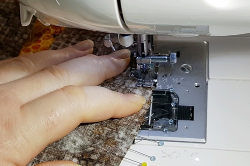 Step 15 Orange Peel Quilt Block: Place a finger on the fabric to the side and in front of the presser foot to help guide the fabric and keep a 1/4 inch seam allowance. Step 15 Orange Peel Quilt Block: Place a finger on the fabric to the side and in front of the presser foot to help guide the fabric and keep a 1/4 inch seam allowance.