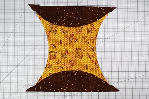 Step 17 Orange Peel Quilt Block: From the right side of the fabric here's how the background piece and first two half melons look after stitching. Step 17 Orange Peel Quilt Block: From the right side of the fabric here's how the background piece and first two half melons look after stitching.