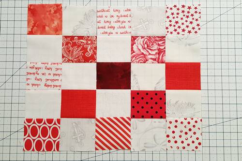 Step 5 Postage Stamp Quilt: Arrange 80 (10 1/2 x 10 1/2 inch) postage stamp quilt blocks alternating red and white units. Step 5 Postage Stamp Quilt: Arrange 80 (10 1/2 x 10 1/2 inch) postage stamp quilt blocks alternating red and white units.