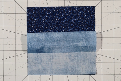 Quarter Square Triangle Tutorial Step 1: Place QST squares right sides together, background square on top. Quarter Square Triangle Tutorial Step 1: Place QST squares right sides together, background square on top.