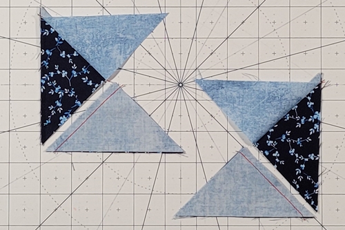 Quarter Square Triangle Tutorial: To get  split (mirror image), stitch two QST pairs along the left edge and two along the right. In the pic the units are sewn with background Fabric B on top. Quarter Square Triangle Tutorial: To get  split (mirror image), stitch two QST pairs along the left edge and two along the right. In the pic the units are sewn with background Fabric B on top.