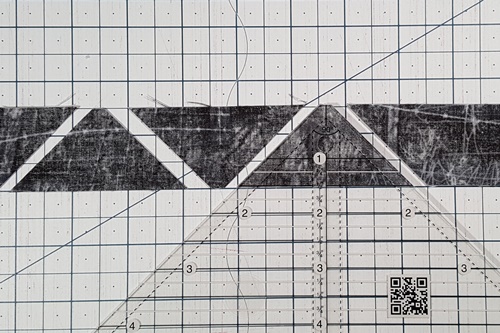 Step 3 How To Use A Quarter Square Triangle Ruler: Continue to rotate the ruler, aligning the ruler as in Steps 1 and 2 to cut QSTs. Step 3 How To Use A Quarter Square Triangle Ruler: Continue to rotate the ruler, aligning the ruler as in Steps 1 and 2 to cut QSTs.