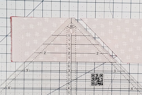 How To Use A Quarter Square Triangle Ruler: cut the first QST in two steps.
Make the first cut along the right edge of the ruler. How To Use A Quarter Square Triangle Ruler: cut the first QST in two steps.
Make the first cut along the right edge of the ruler.