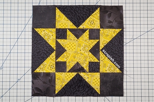 Picture of a double sawtooth star quilt block stitched together.