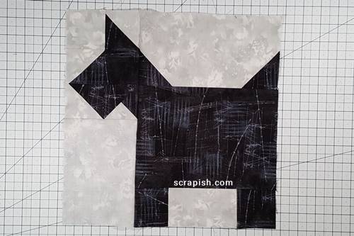 Step 12 Cat Quilt Block Pattern: Stitch the ear unit to the body unit. Press the seam up, toward the ear unit.