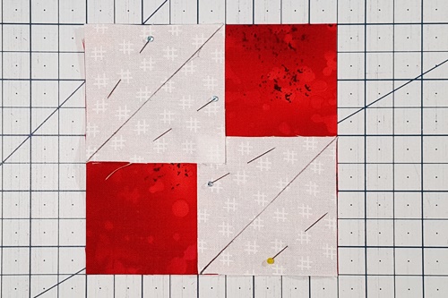 Step 3 Square in a Square: With the right sides together, place a small square in two opposite corners of the larger square (Fabric A) and pin in place. Step 3 Square in a Square: With the right sides together, place a small square in two opposite corners of the larger square (Fabric A) and pin in place.