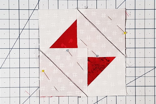 Step 5a Square in a Square: right sides together, place small square in opposite corners of remaining two corners of larger square. Pin in place. Stitch on the drawn lines. Step 5a Square in a Square: right sides together, place small square in opposite corners of remaining two corners of larger square. Pin in place. Stitch on the drawn lines.