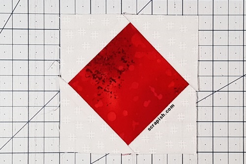 Step 5d Square in a Square: Flip what remains of the small squares right side up to reveal the square in a square unit. Press the seams towards triangles. Step 5d Square in a Square: Flip what remains of the small squares right side up to reveal the square in a square unit. Press the seams towards triangles.