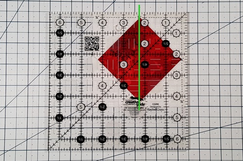 To square up the unit, divide the unfinished size in half. Place this measurement line of a quilting ruler on the vertical center of the unit. To square up the unit, divide the unfinished size in half. Place this measurement line of a quilting ruler on the vertical center of the unit.