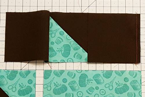 Step 3c With right sides together, place second square on top of flying geese unit along its right edge, aligning raw edges. Stitch together using a 1/4 inch seam for this star quilt block pattern.