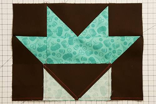 Step 7c Sew Row 3 to Row 2. The the top of Row 3 should be sewn to bottom of Row 2. Press the seam downward, toward row 3, the flying geese unit of this star quilt block pattern.